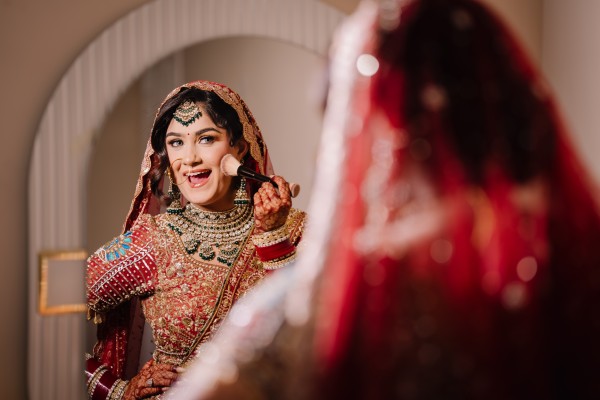 New York bridal photography captures a bride getting ready with elegant jewelry, makeup, traditional attire, and real emotion