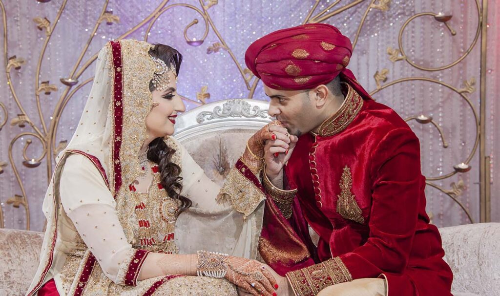 Romantic Indian wedding moment of bride and groom seated together during traditional ceremony captured in Floral Park, New York by Citi Events Productions